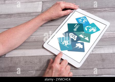 Climate change concept shown on a tablet used by a woman Stock Photo