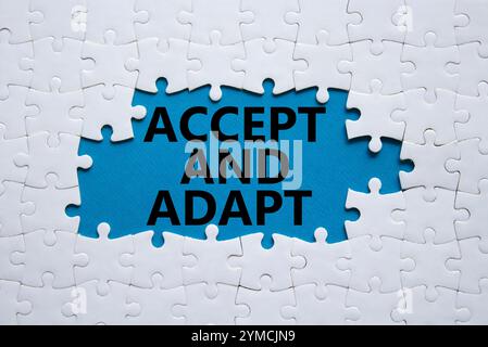 Accept or adapt symbol. Concept words Accept and adapt on white puzzle. Beautiful blue background. Business and Accept and adapt concept. Copy space. Stock Photo