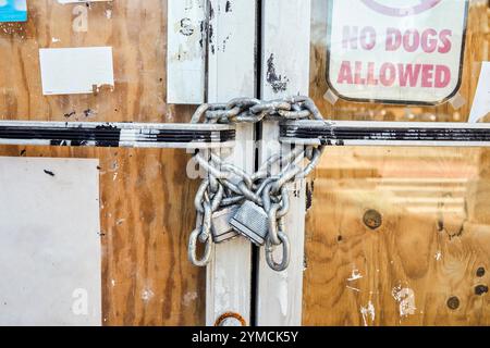Close-up of chain and padlock on boarded up door Stock Photo