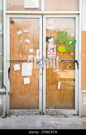 Chain and padlock on boarded up door Stock Photo