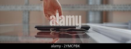 Website header shot of female hand unlocking office door using touch screen on wall, modern security system concept, copy space Stock Photo