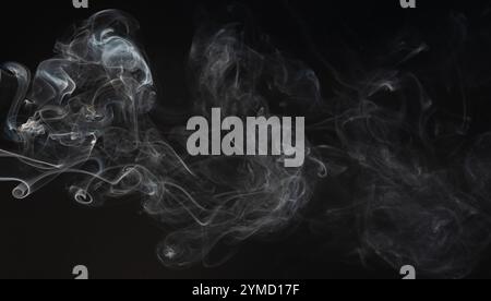 Gray smoke lines on black studio background Stock Photo