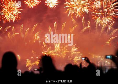 People Watching And Recording Fireworks Stock Photo