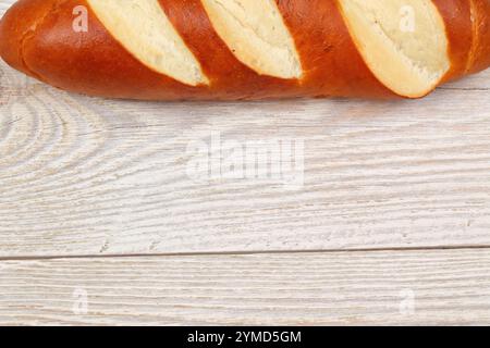 Freshly Baked Bread on a Rustic Wooden Surface, with Several Slices Displayed Neatly Stock Photo