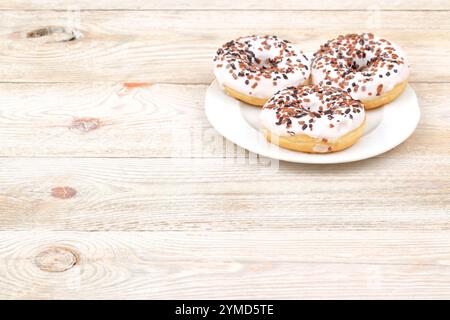 A tempting assortment of colorful donuts topped with icing and sprinkles on a plate Stock Photo
