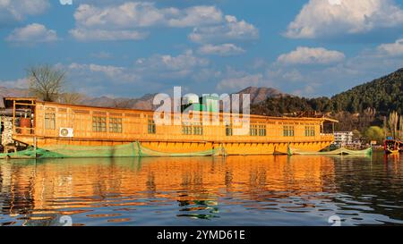 Beautiful houseboat .Kashmir's houseboats, floating palaces on the serene Dal Lake, offer a unique blend of luxury and tradition. Stock Photo