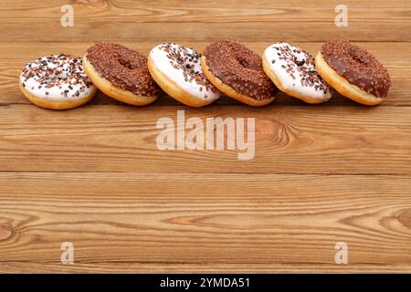 A beautiful arrangement of assorted donuts beautifully displayed on a rustic wooden table Stock Photo
