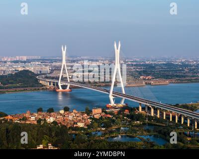 Foshan. 21st Nov, 2024. An aerial drone photo taken on Nov. 21 2024 shows a view of the Fulong Xijiang super major bridge in Foshan, south China's Guangdong Province. Lying in Foshan City, the 1770.6-meter-long bridge connects Gaoming District in the west and Sanshui District in the east. The bridge, scheduled to open to traffic on Friday, will further improve the transportation system of the western area of Guangzhou and Foshan in south China's Guangdong. Credit: Liu Dawei/Xinhua/Alamy Live News Stock Photo