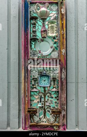 On a wall next to the Aruba Viaduct in Willemstad, collages of collector's items from Curaçao, all signed TOPO 13, hang inconspicuously on discarded window frames. Willemstad, Curaçao, Curacao, Kòrsou Stock Photo