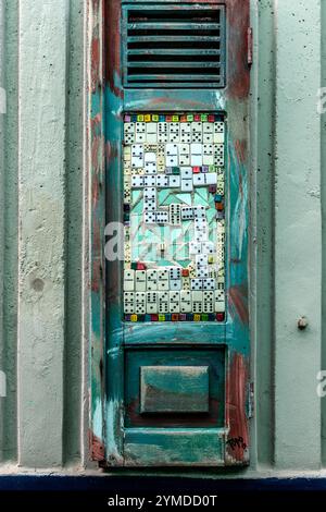 On a wall next to the Aruba Viaduct in Willemstad, collages of collector's items from Curaçao, all signed TOPO 13, hang inconspicuously on discarded window frames. Willemstad, Curaçao, Curacao, Kòrsou Stock Photo