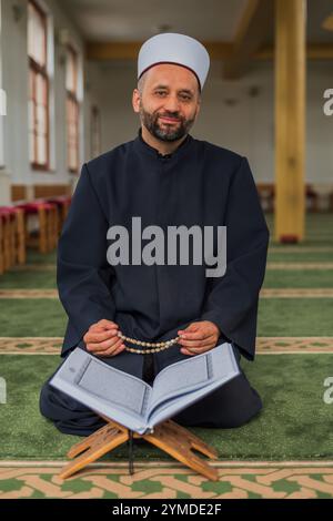 A Muslim man prayer praying inside the mosque. Stock Photo