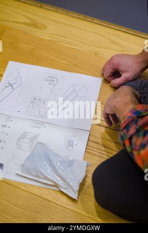 man furniture assembly instructions and laid on the floor side, top view. High quality photo Stock Photo