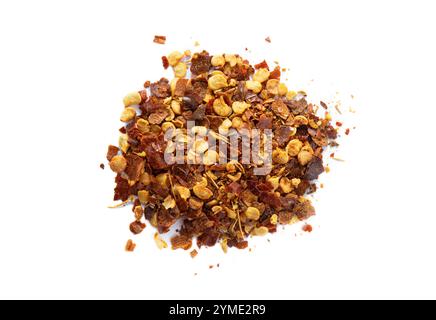 Homemade powdered dried red chili powder flakes. Asian food seasoning. Above view, studio shot isolated on white background. Stock Photo