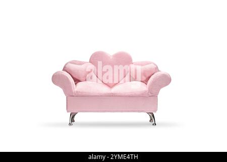 Pink velvet sofa with heart pillows isolated on white background Stock Photo