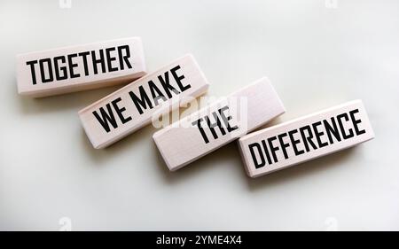 Together we will change the text on the wooden blocks on a white background Stock Photo