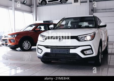 White and red cars parked inside Stock Photo