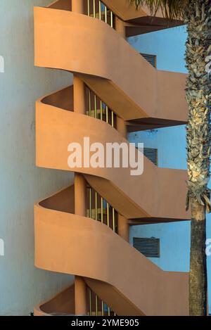 A concrete spiral staircase on the outside of a building in Salou, Costa Dorada, Catalonia, Spain Stock Photo