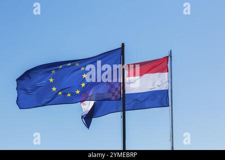 Close-up of European Union and Croatian national flags billowing in the wind against a clear blue sky, Zadar, Croatia, Europe Stock Photo