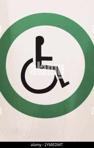 Close-up of posted white metal with black wheelchair in green circle Reserved Handicap Parking Spot pictogram notice sign outdoors, Quebec, Canada, No Stock Photo