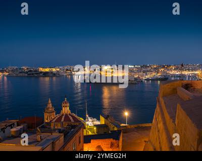 View of the three cities and Grand harbour at night from Valletta, Malta 2024 Stock Photo