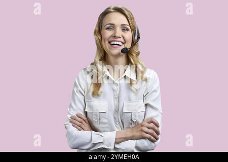 Portrait of happy smiling call center agent looking at camera. Call center operator with headset on color background Stock Photo