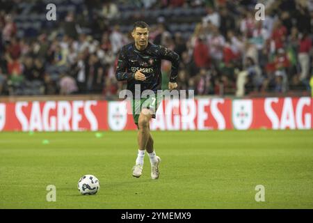 Football match, Cristiano RONALDO CR7 Portugal warming up in front of the match jumping slightly high in front of shooting left on goal with ball, Est Stock Photo