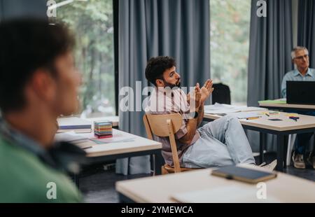 Students engaging with elderly professor in a modern classroom setting Stock Photo