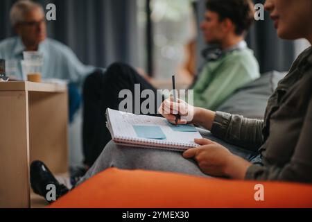 Professor interacting with engaged students during study session Stock Photo