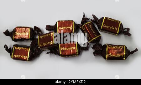 Unbranded wrapped chocolate caramels on a white background Stock Photo