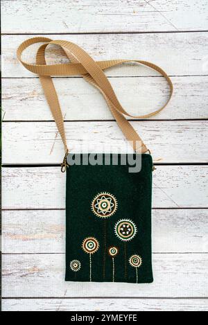 Handmade craft fabric bag on wooden background. Stock Photo