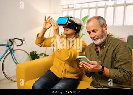 Senior couple exploring virtual reality at home Stock Photo