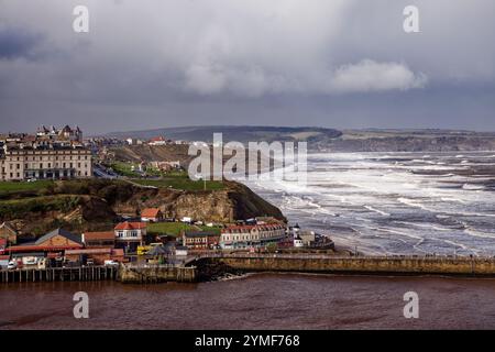 Rain clearing in the view towards Sandsend with Whitby seafront in the foreground, Whitby, North Yorkshire, England. Stock Photo