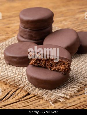 Brazilian Pao de Mel or chocolate covered honey cookies over a wooden table. Stock Photo