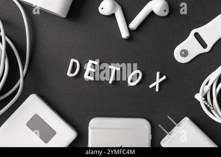 Composition with word DETOX and different modern gadgets on dark background Stock Photo