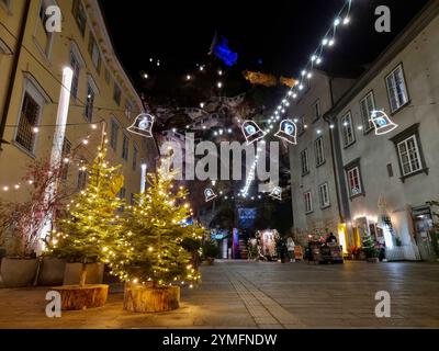 Graz, Austria-26.11.2022: People walking on a street with beautiful Christmas decorations at night, in the city center of Graz, Styria region, Austria Stock Photo