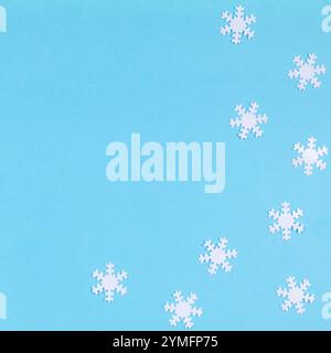 White snowflakes on blue background, Christmas square poster, Merry Christmas and Happy New Year concept, top view, copy space Stock Photo