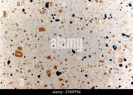 Fragment of a pink surface with inclusions of stones of different colors and sizes. For use as an abstract background and textures. Stock Photo