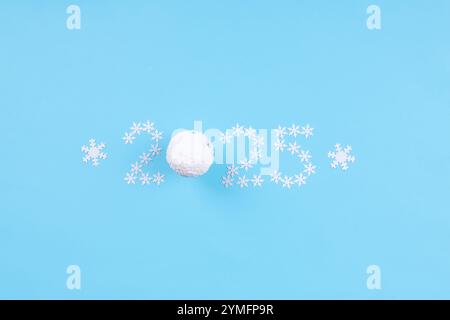 Minimalist New Year 2025 design showcasing the number 2025 created from small white snowflakes on bright blue background Stock Photo