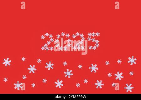 Festive New Year 2025 design featuring the number "2025" formed from small white snowflakes on vibrant red background. Additional snowflakes are scatt Stock Photo