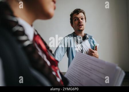 College students engaging with professor in outdoor setting Stock Photo