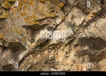 Corbieres, Languedoc, France - November 20th 2024 - Rugged stone backgroundwith bright yellow lichen Stock Photo