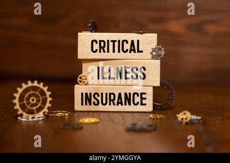 Medicine concept. On the blue surface lies a jar of pills and a clip with paper on which is written - Critical Illness Insurance Stock Photo