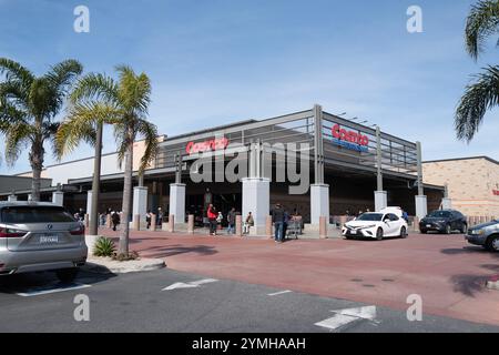 Images of a bustling Costco store featuring the exterior, entrance, and checkout areas, capturing customers and carts in action. Stock Photo