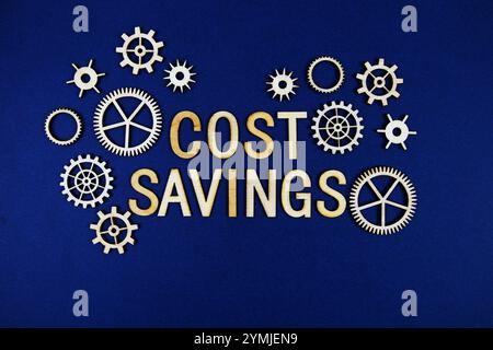 Cost Savings alphabet letters with gears element on navy blue background Stock Photo