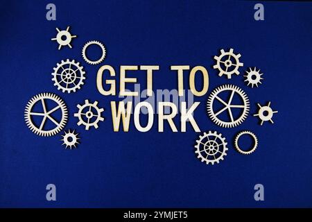 Get to Work alphabet letters with gears element on navy blue background Stock Photo