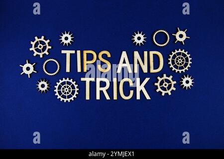 Tips and Trick alphabet letters with gears element on navy blue background Stock Photo
