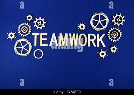Teamwork alphabet letters with gears element on navy blue background Stock Photo