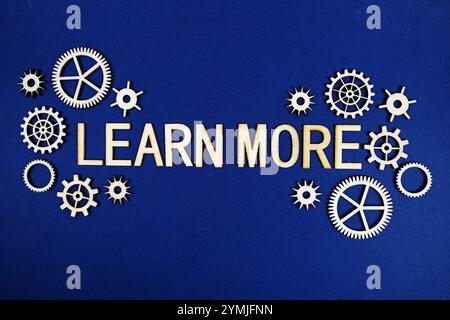 Learn More alphabet letters with gears element on navy blue background Stock Photo