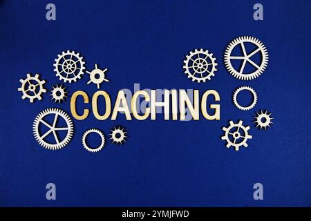 Coaching alphabet letters with gears element on navy blue background Stock Photo