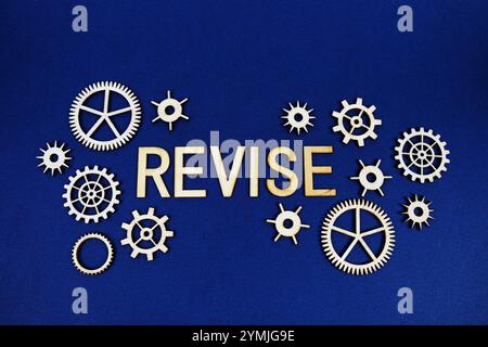 Revise alphabet letters with gears element on navy blue background Stock Photo
